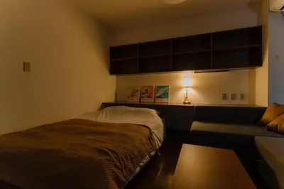 a small bedroom with a bed and a couch at Villa mitamura301VM31 in Tokyo