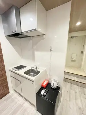 a small kitchen with a sink and a counter at fukuhana \u6771\u65b0\u5bbf2 in Tokyo
