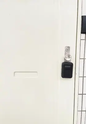 a close up of a white door with a clock on it at fukuhana \u6771\u65b0\u5bbf2 in Tokyo