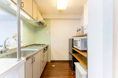 a kitchen with white cabinets and a sink at Villa mitamura 303 VM33 in Tokyo