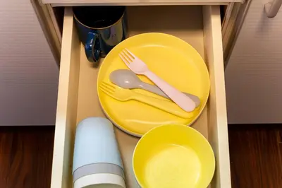 a yellow plate with a fork and knife on it in a drawer at Villa mitamura 303 VM33 in Tokyo