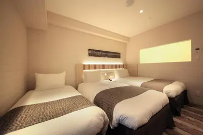 a hotel room with two beds in a room at Hotel Sunroute Ginza in Tokyo