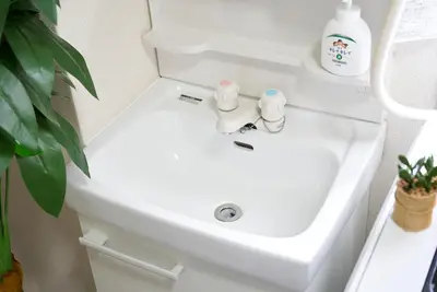 a white sink in a bathroom with a plant at Belmont 303 3min to Station Easy Access Ueno Asakusa Skytree Sleeps 4 in Tokyo