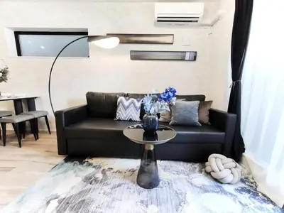 a living room with a couch and a table at \u65b0\u5bbf2\u7ad9 \u6c60\u888b\u5168\u65b0\u72ec\u7acb3\u5c42\u522b\u5885 3\u5ba41\u53851\u6d74\u5ba4 \u6700\u59278\u4eba max 8P \u8f66\u7ad97\u5206\u949f 7mins to ST \u94f6\u5ea7 \u65b0\u5bbf \u6d89\u8c37 \u6c60\u888b \u4e1c\u4eac\u76f4\u901a in Tokyo