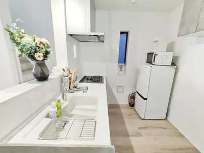 a white kitchen with a sink and a refrigerator at \u65b0\u5bbf2\u7ad9 \u6c60\u888b\u5168\u65b0\u72ec\u7acb3\u5c42\u522b\u5885 3\u5ba41\u53851\u6d74\u5ba4 \u6700\u59278\u4eba max 8P \u8f66\u7ad97\u5206\u949f 7mins to ST \u94f6\u5ea7 \u65b0\u5bbf \u6d89\u8c37 \u6c60\u888b \u4e1c\u4eac\u76f4\u901a in Tokyo