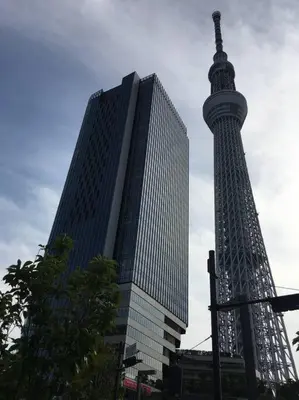 a tall building with a tower in front of it at Sky sweet home in Tokyo