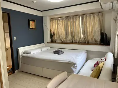 a small bedroom with a bed and a window at Sky sweet home in Tokyo