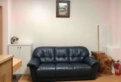 a black leather couch sitting in a living room at Japanese-style house detached house in Tokyo