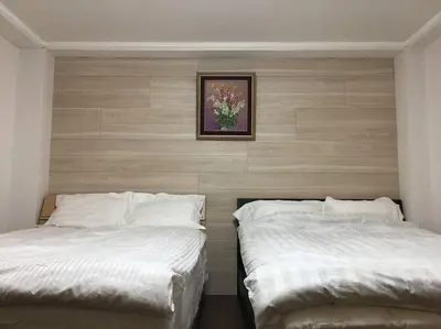 two beds sitting next to each other in a bedroom at Japanese-style house detached house in Tokyo