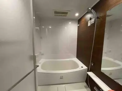 a white bathroom with a tub and a sink at Japanese-style house detached house in Tokyo