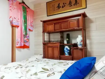 a bedroom with a bed and a wooden cabinet at Japanese-style house detached house in Tokyo