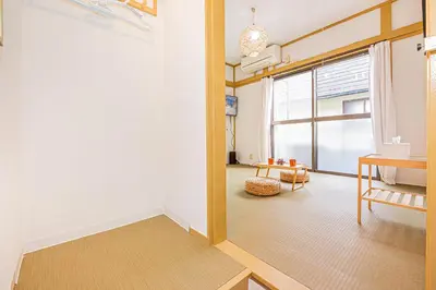 a living room with a table and a window at sunrise 2 in Tokyo