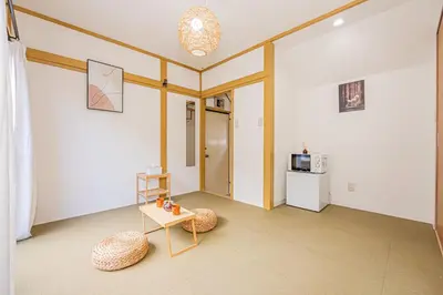 a living room with a table and a microwave at sunrise 2 in Tokyo