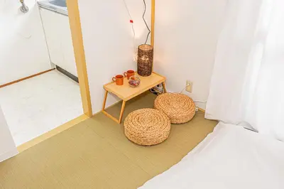 a bedroom with a bed and a table and a mirror at sunrise 2 in Tokyo