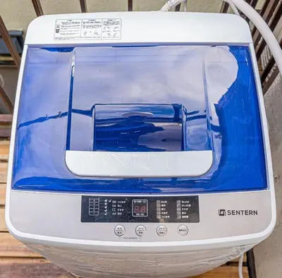 a blue and white toaster sitting on a table at sunrise 2 in Tokyo