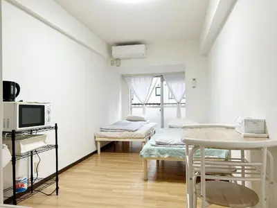 a hospital room with two beds and a tv at \u65b0\u5bbf\u4e2d\u5fc3#\u6b4c\u821e\u4f0e#Shinjuku 3min walk#\u5730\u94c1\u7ad9\u6b65\u884c3\u5206#JR\u65b0\u5bbf\u7ad9\u6b65\u884c9\u5206\u949f#\u97e9\u56fd\u57ce#\u9ad8\u901f\u65e0\u9650\u5236\u7f51\u8def#\u81ea\u52a8Autolock\u5927\u95e8411 in Tokyo
