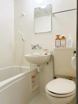 a white bathroom with a toilet and a sink at \u65b0\u5bbf\u4e2d\u5fc3#\u6b4c\u821e\u4f0e#Shinjuku 3min walk#\u5730\u94c1\u7ad9\u6b65\u884c3\u5206#JR\u65b0\u5bbf\u7ad9\u6b65\u884c9\u5206\u949f#\u97e9\u56fd\u57ce#\u9ad8\u901f\u65e0\u9650\u5236\u7f51\u8def#\u81ea\u52a8Autolock\u5927\u95e8411 in Tokyo