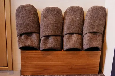 a row of brown cushions on a wooden shelf at Harebare apartment for max 3ppl 3mins walk from Kiba station 2F in Tokyo