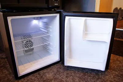 an empty refrigerator with its door open in a room at Harebare apartment for max 3ppl 3mins walk from Kiba station 2F in Tokyo
