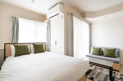 a bedroom with a large white bed and a window at \u30ac\u30fc\u30e9\u30d7\u30ec\u30a4\u30b9\u9326\u7cf8\u753a in Tokyo
