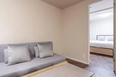 a living room with a couch and a bed at Apartment\u5c0f\u77f3\u5ddd\u5f8c\u697d\u5712 in Tokyo