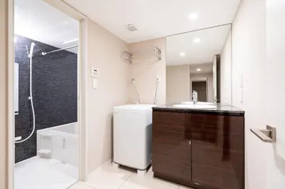 a bathroom with a sink and a toilet and a shower at Apartment\u5c0f\u77f3\u5ddd\u5f8c\u697d\u5712 in Tokyo