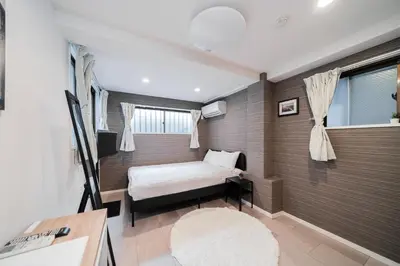 a small bedroom with a bed and a window at MX House - Cozy APT Stay in Ikebukuro Tokyo, with Direct Access to Shinjuku & Shibuya in Tokyo