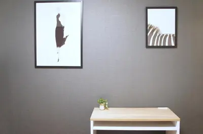 three pictures hanging on a wall with a table at MX House - Cozy APT Stay in Ikebukuro Tokyo, with Direct Access to Shinjuku & Shibuya in Tokyo