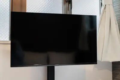 a flat screen tv hanging on a wall at MX House - Cozy APT Stay in Ikebukuro Tokyo, with Direct Access to Shinjuku & Shibuya in Tokyo
