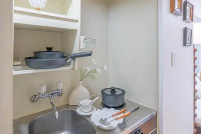 a kitchen sink with pots and pans on a shelf at Nakano106,Nakano Broadway,Shinjuku 1 stop in Tokyo