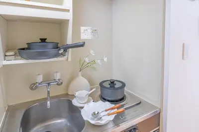 a kitchen sink with pots and pans on a stove at Nakano106,Nakano Broadway,Shinjuku 1 stop in Tokyo