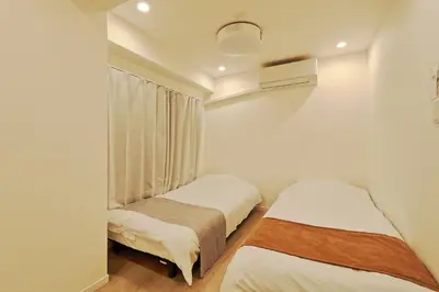 a bedroom with two beds and a window at V Close to Shinjuku Kabukicho Korean Town FrWIFI I in Tokyo