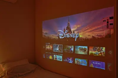 a bedroom with a tv on a wall with pictures at V Close to Shinjuku Kabukicho Korean Town FrWIFI I in Tokyo