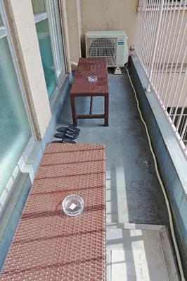 a table and a bench on a porch with a window at V Close to Shinjuku Kabukicho Korean Town FrWIFI I in Tokyo