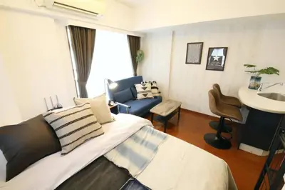 a bedroom with a bed and a sink and a chair at Gaia Kabukicho 301 \u30ac\u30a4\u30a2\u6b4c\u821e\u4f0e\u753a in Tokyo