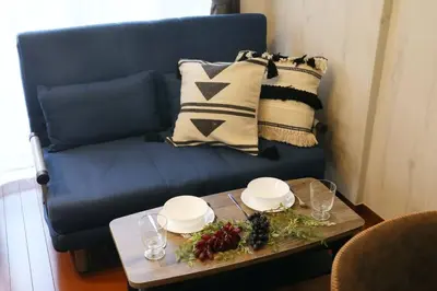 a blue couch with a table and a blue chair at Gaia Kabukicho 301 \u30ac\u30a4\u30a2\u6b4c\u821e\u4f0e\u753a in Tokyo