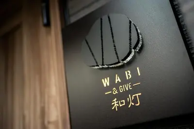 a sign that says wabb and glue on a wall at WABI & GIVE Nakano Araiyakushi in Tokyo