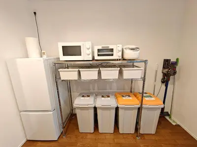 a kitchen with three trash cans and a refrigerator at SunshineHouse \u4eac\u5cf6 \u6210\u7530\u7fbd\u7530\u76f4\u901a \u9002\u54086\u540d\u6700\u59278\u540d in Tokyo