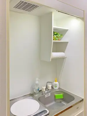 a small kitchen with a sink and a mirror at Nakano 102 Walking 4 Mins Broadway Shinjuku 1 stop in Tokyo