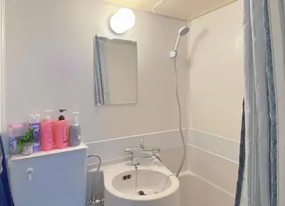 a bathroom with a sink and a mirror at Nakano 102 Walking 4 Mins Broadway Shinjuku 1 stop in Tokyo
