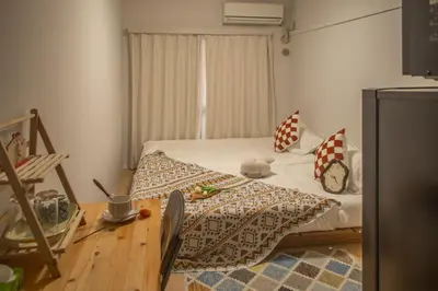 a bedroom with a bed with a clock on it at Nakano 103 Walking 4 Mins Broadway Shinjuku 1 stop in Tokyo