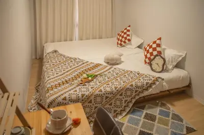 a small bedroom with a bed with a table and a table at Nakano 103 Walking 4 Mins Broadway Shinjuku 1 stop in Tokyo
