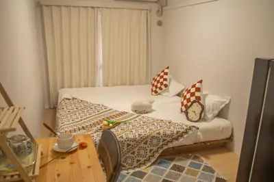 a small bedroom with a bed and a table at Nakano 103 Walking 4 Mins Broadway Shinjuku 1 stop in Tokyo