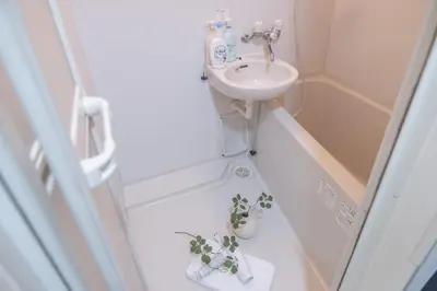 a small bathroom with a sink and two potted plants at Nakano101,Nakano Broadway,Shinjuku 1 stop in Tokyo
