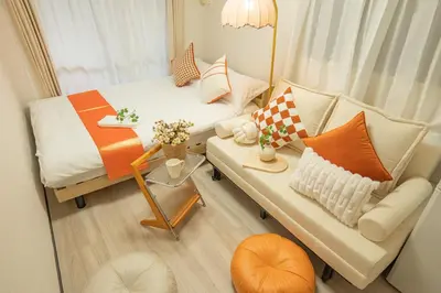 a small room with a bed and a couch at Nakano101,Nakano Broadway,Shinjuku 1 stop in Tokyo