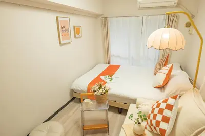 a small room with two beds and a lamp at Nakano101,Nakano Broadway,Shinjuku 1 stop in Tokyo
