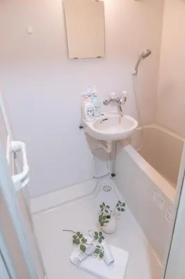 a bathroom with a sink and a plant on the floor at Nakano101,Nakano Broadway,Shinjuku 1 stop in Tokyo