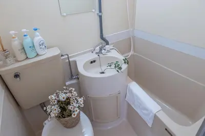 a small bathroom with a toilet and a sink at Nakano Walking 4 Mins Broadway Shinjuku 1 stop in Tokyo