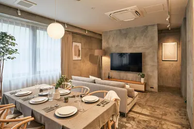 a dining room with a table and a couch at Spacious Tokyo Base near Tamachi station Hotel Ten Tamachi in Tokyo