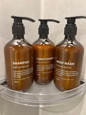three bottles of shampoo and conditioner on a shelf at Spacious Tokyo Base near Tamachi station Hotel Ten Tamachi in Tokyo